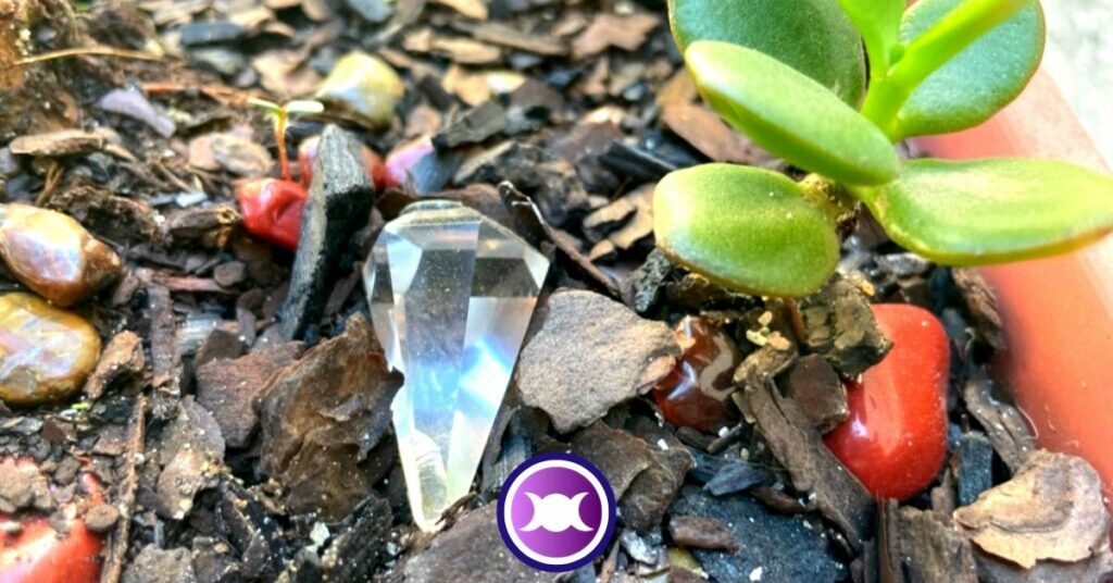 A broken quartz crystal pendulum in the garden